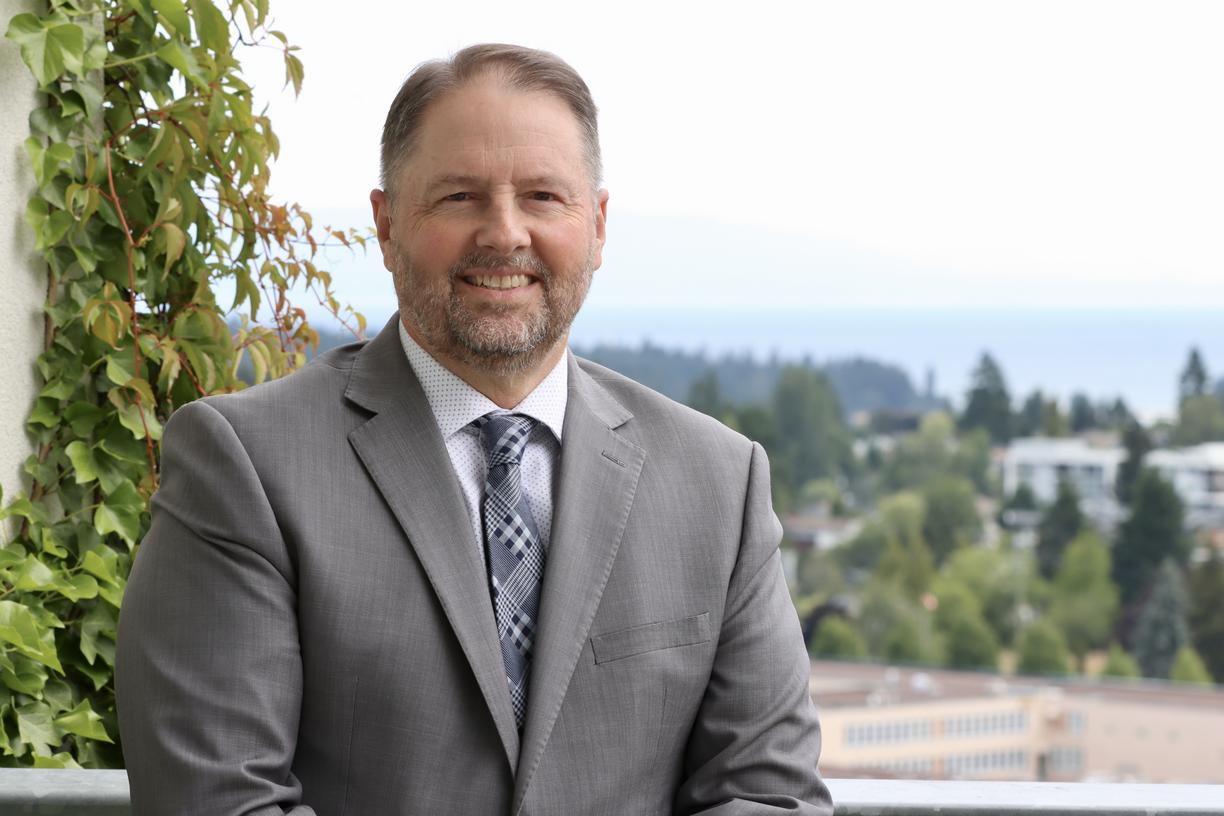Dennis Johnson with a view of the Nanaimo campus and greenery behind him