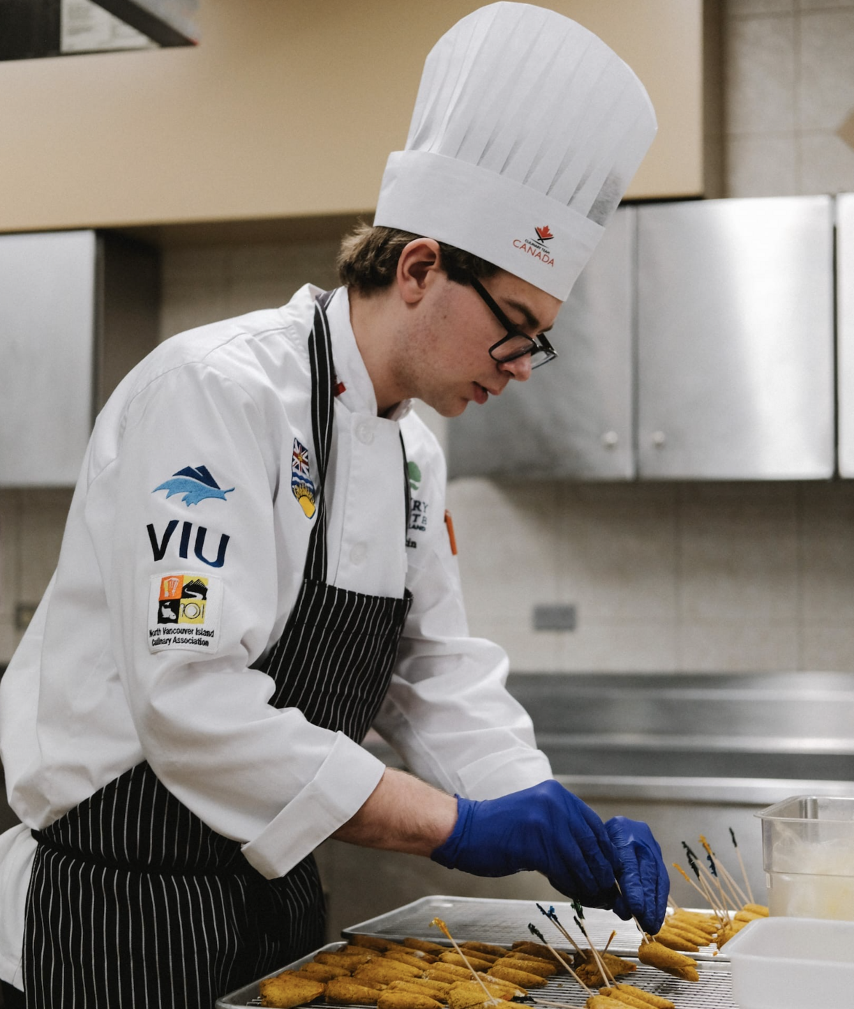 Simon Martin preaparing food in a professional kitchen.