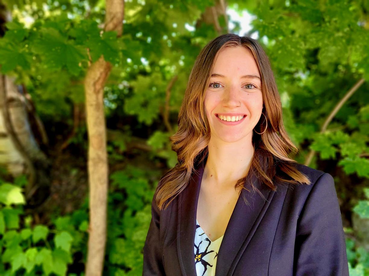 Megan Fortune in front of green foliage