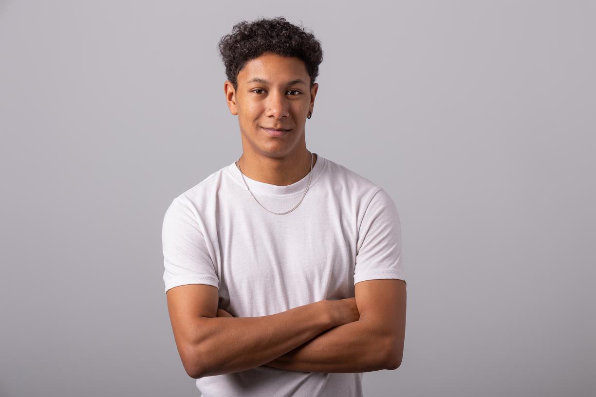 Michael Joseph standing with his arms crossed and smiling at the camera.