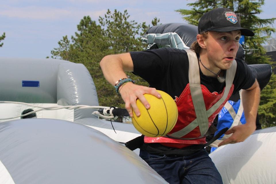 A student runs with a ball