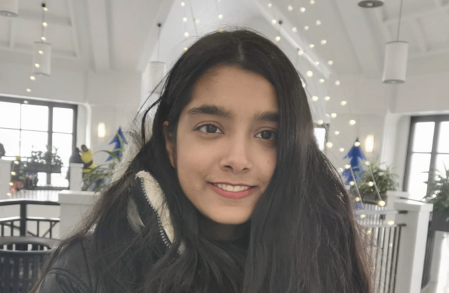 Sharan Gill smiling at the camera.