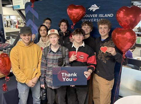 group of students holding heart cookies and a thank you sign