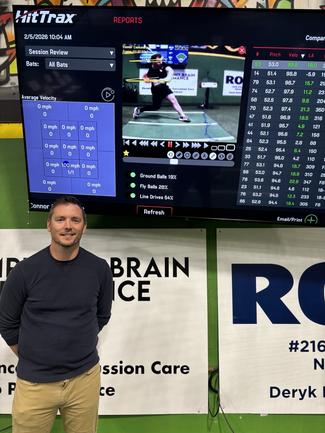 Jordan Herbsion standing in front of some of the sports technology that youth athletes use