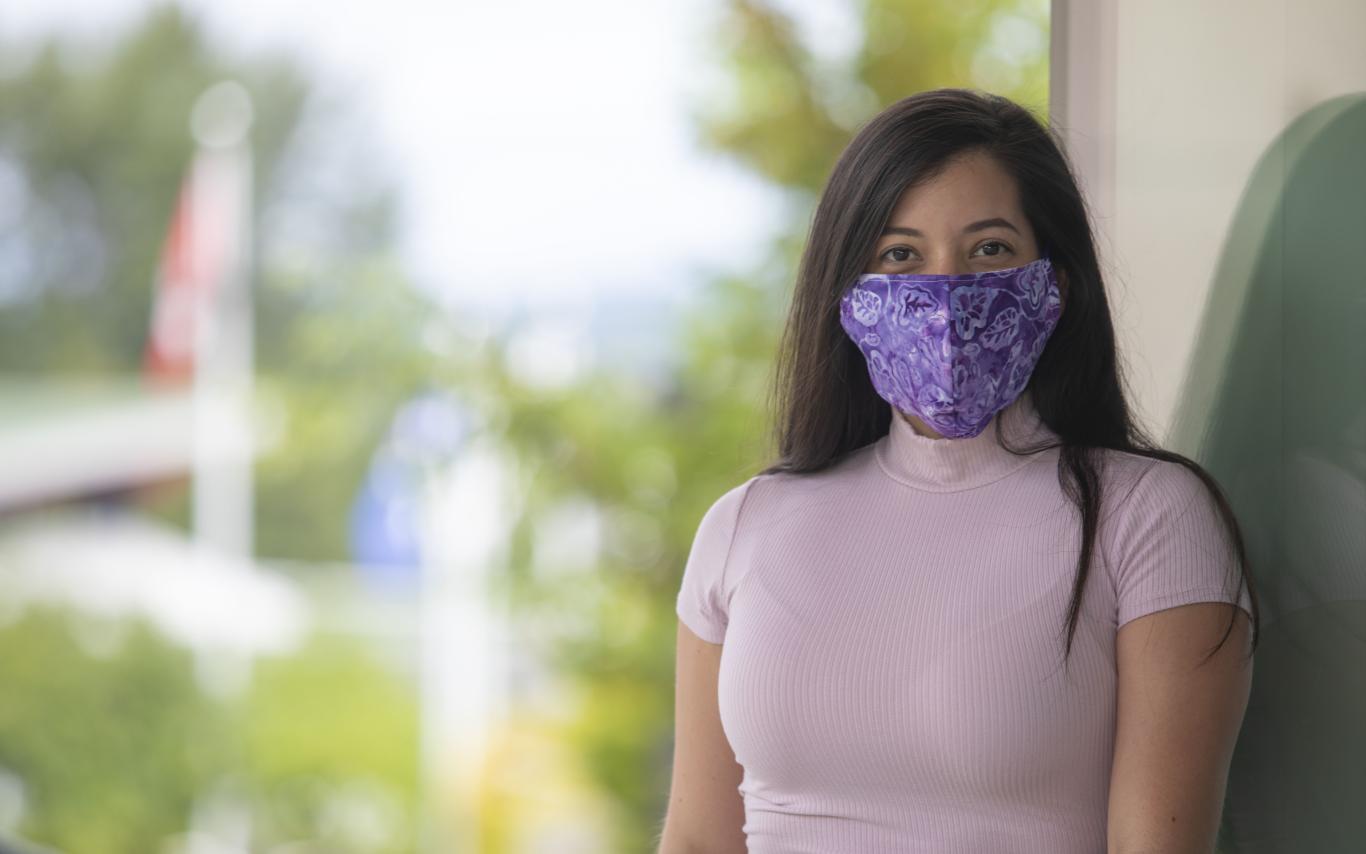 Student sitting wearing a mask