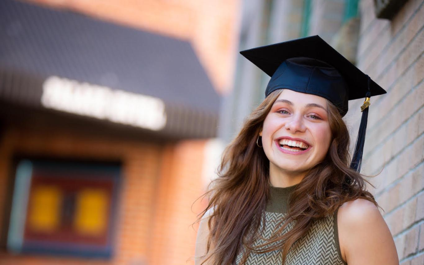 Portrait shot of Lurana wearing a grad cap