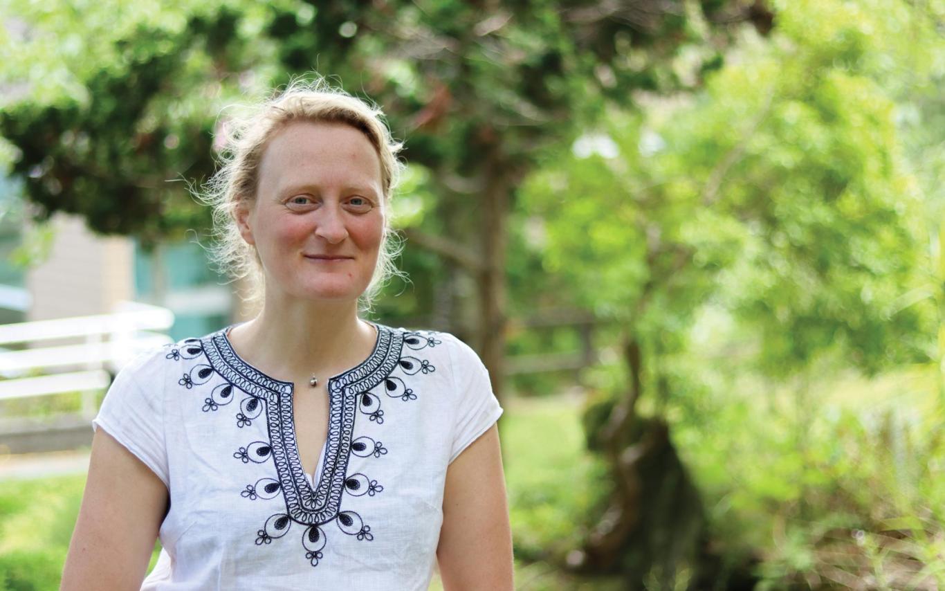 Jenni Ottilie Keppler stands on the koi pond bridge at Vancouver Island University's Nanaimo campus.