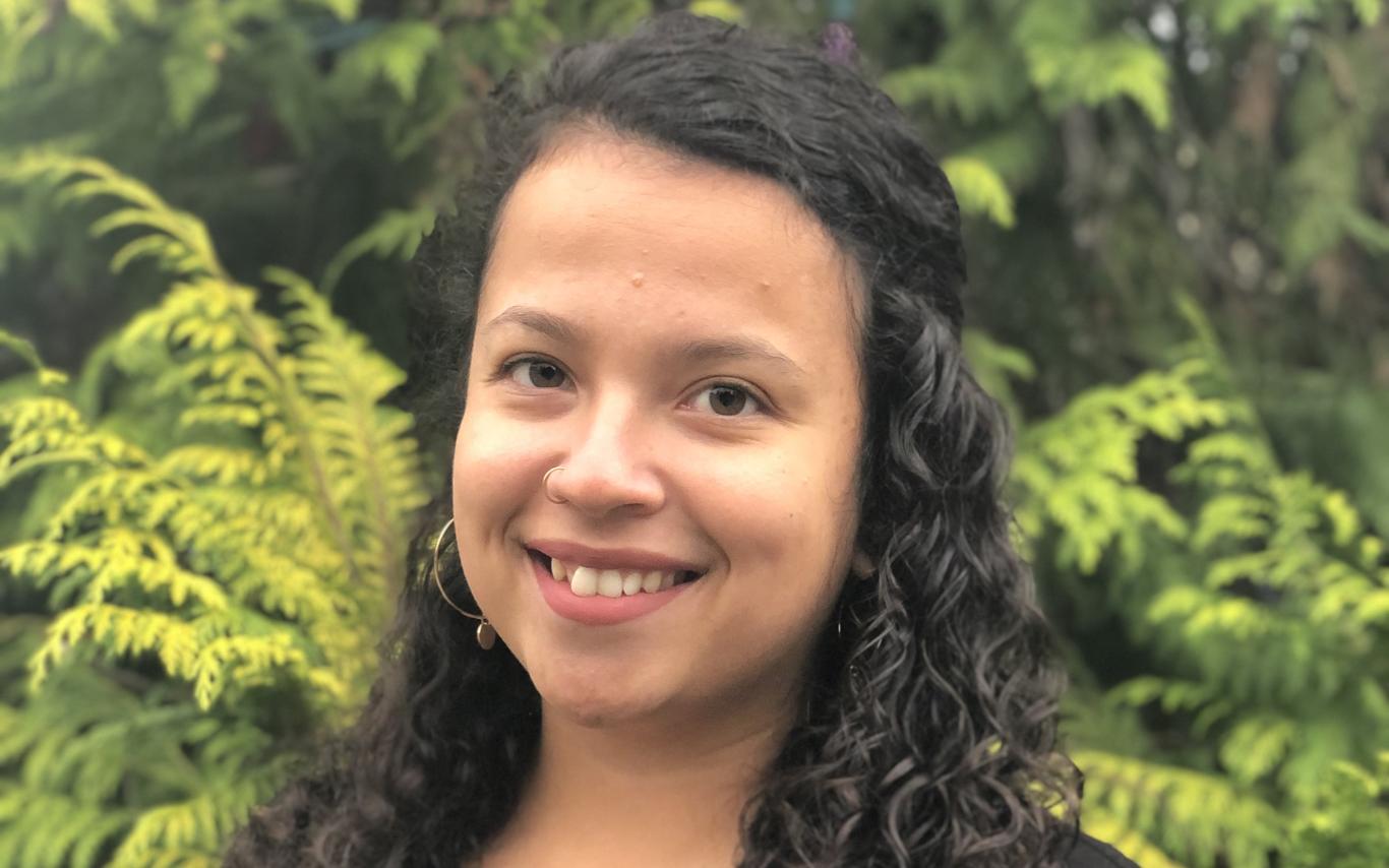 Portrait photo of Taylor in front of some foliage